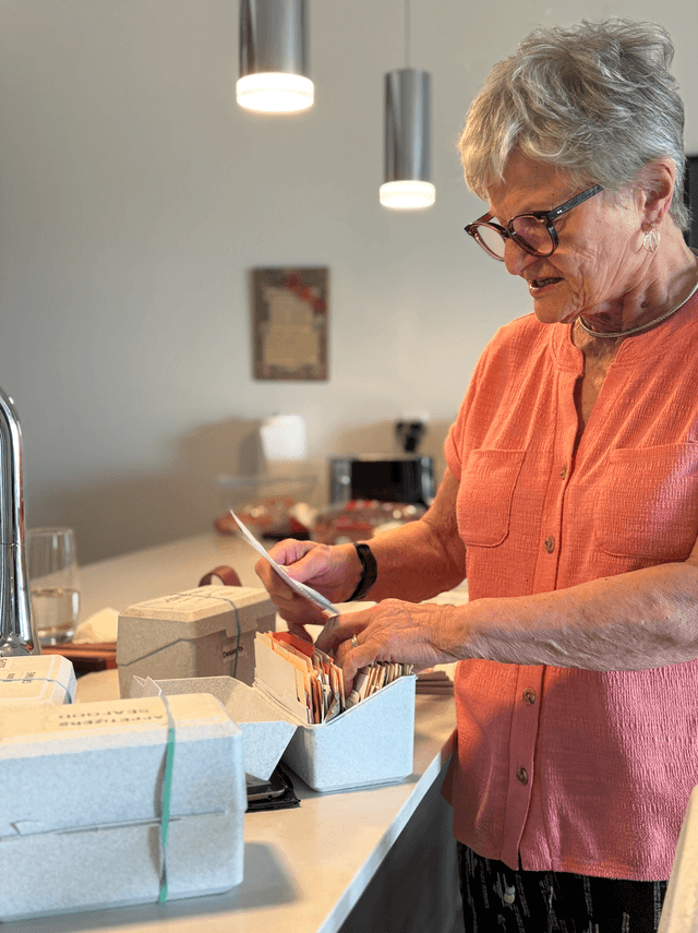 David's mom looking through her recipe boxes